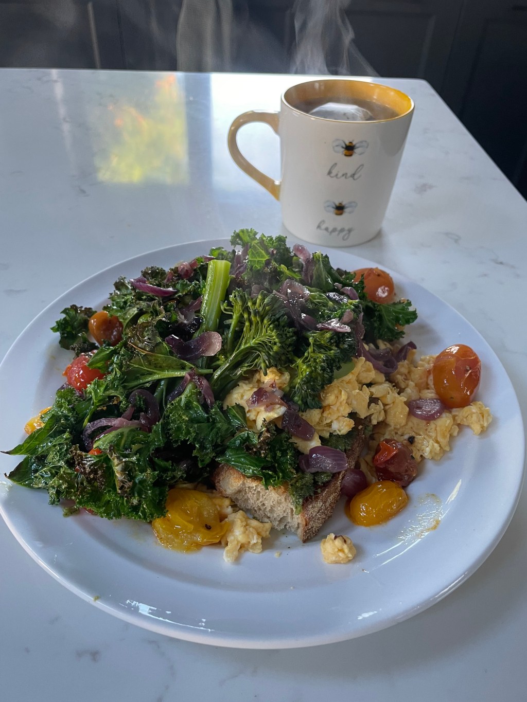 Picture of beautiful brunch meal with eggs and greens on sourdough bread and roasted tomatoes